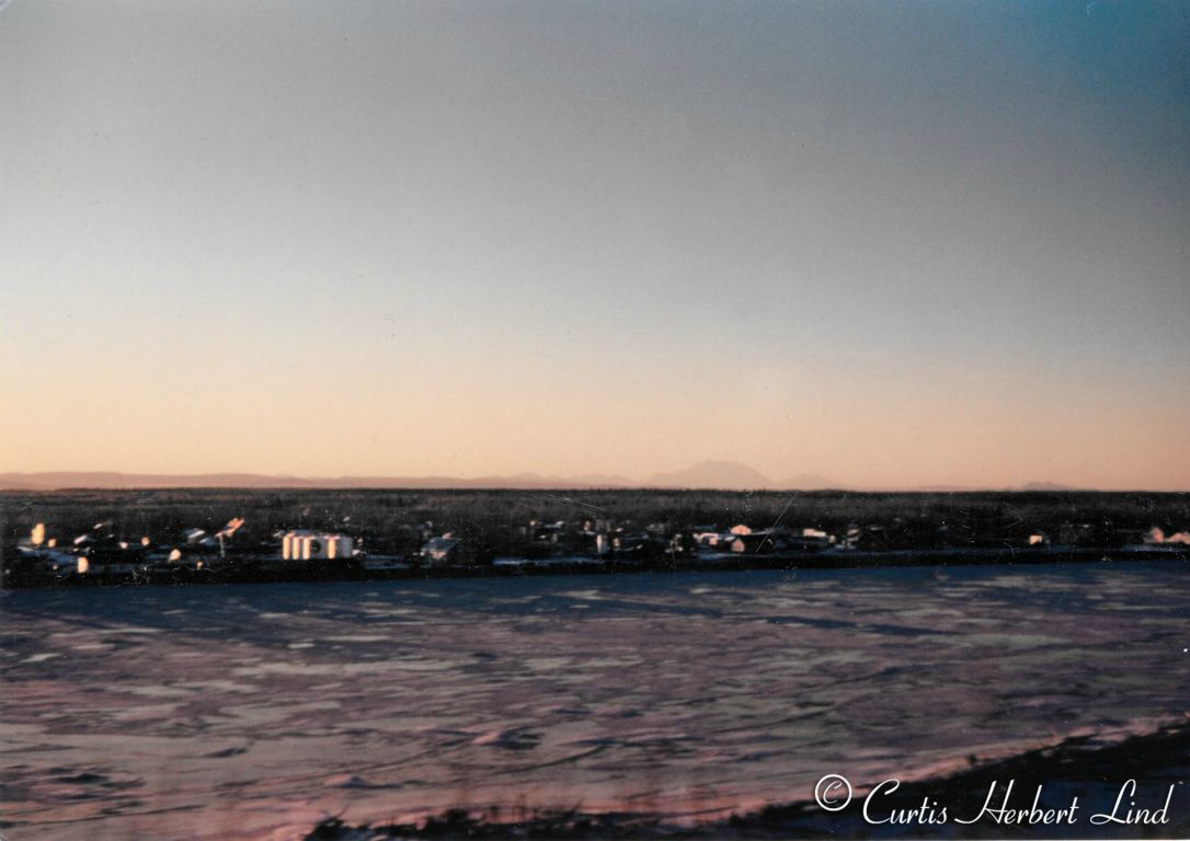 Looks like a view of Fairbanks looking South across the Chena River. Denali can just be made out in the haze at about 1 o’clock.