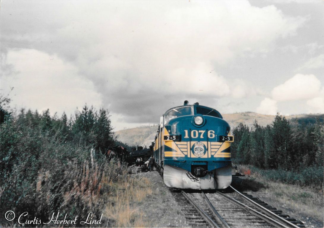 ALCO 1076, the more handsome brother of 1050, is making a flag stop to pick up passengers in the out back. These locomotives came into service in 1949.